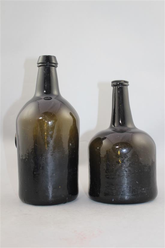 Two English dark green glass wine bottles, 18th century, 25cm.